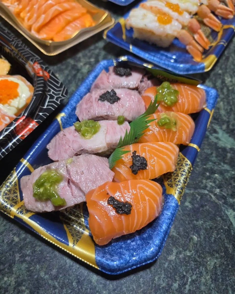 Roasted Wagyu and salmon sushi with green and dark toppings