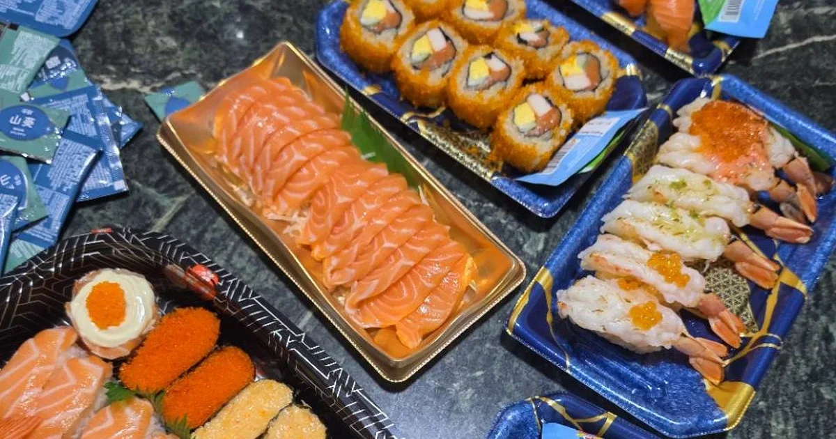 Affordable sushi spread with salmon sashimi, maki and prawn nigiri