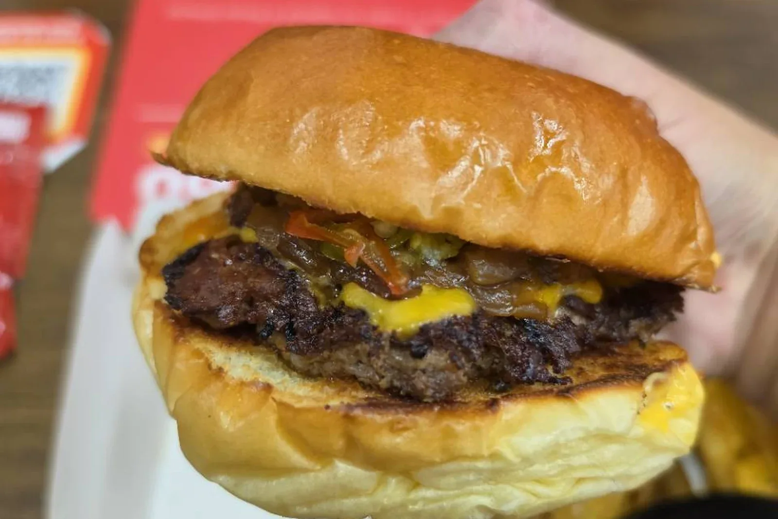 A juicy Burgs beef burger with cheese and pickled chillies
