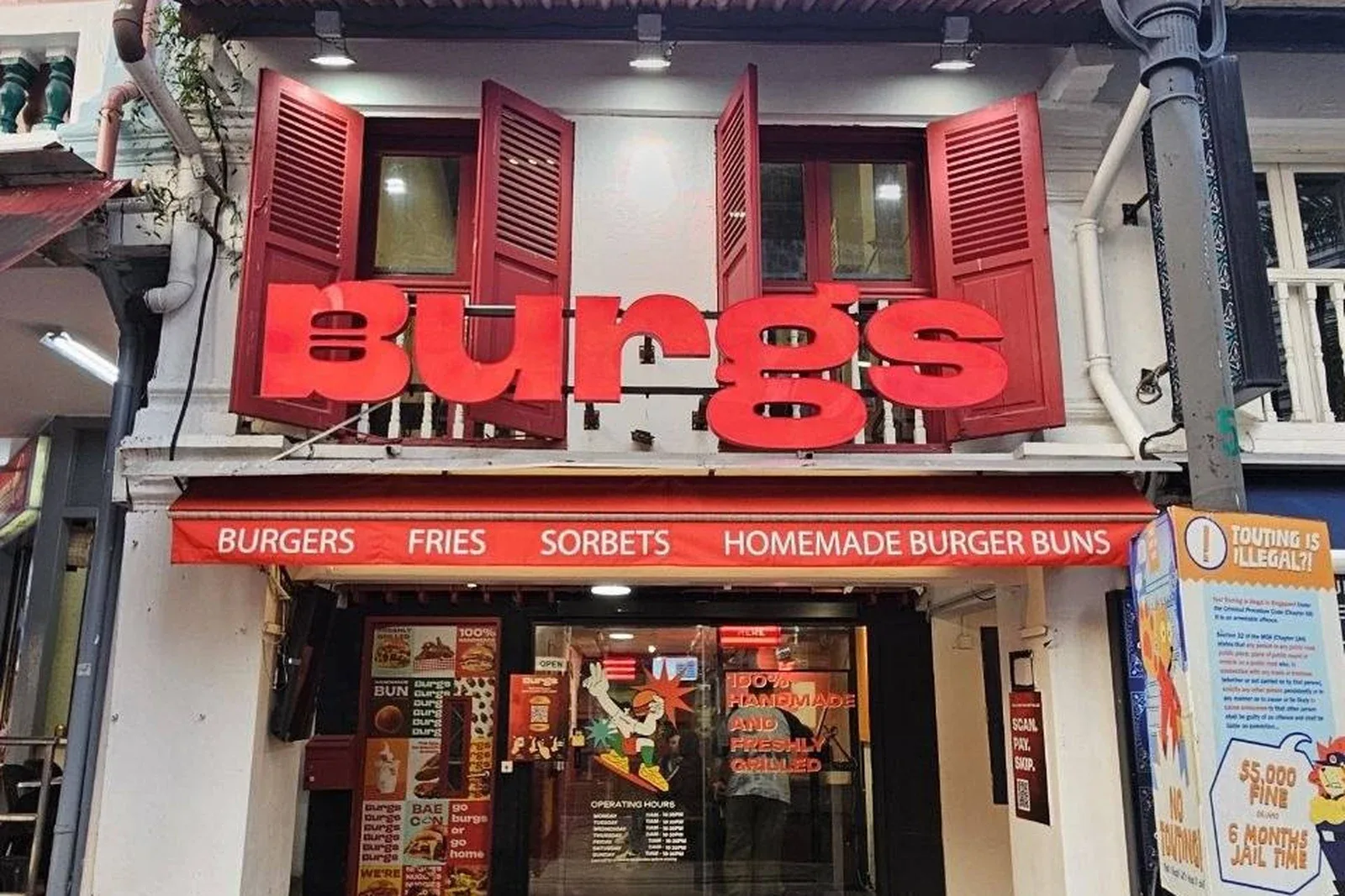 The red Burgs storefront at 16 Bussorah Street